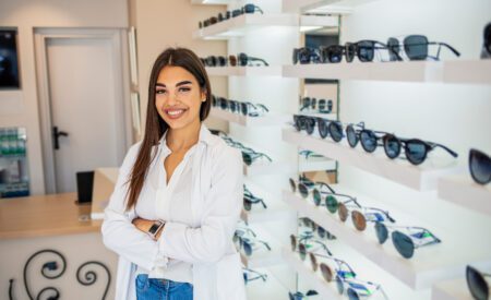 Female optician selling glasses in a store