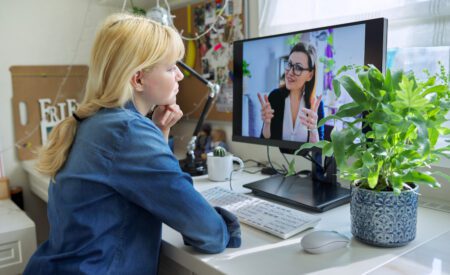 Woman sitting at a desk taking a video call